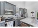 Well-equipped kitchen with gray cabinetry, marble countertops, and modern appliances at 11657 Moore Rd, Lakeland, FL 33809
