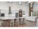 Bright kitchen with island, breakfast bar, stainless steel appliances, and stylish cabinetry creating an ideal culinary space at 11657 Moore Rd, Lakeland, FL 33809