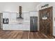 Modern kitchen features white cabinets, subway tile backsplash, stainless steel appliances, pantry, and sleek countertops at 11657 Moore Rd, Lakeland, FL 33809