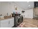 Laundry room with modern washer and dryer features ample countertop and storage space at 11657 Moore Rd, Lakeland, FL 33809
