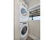 Laundry room with stackable washer and dryer, with a window at 11657 Moore Rd, Lakeland, FL 33809
