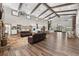Large open living space features hardwood floors, exposed beams, and an open floor plan at 11657 Moore Rd, Lakeland, FL 33809