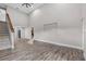 Open concept living room showcasing hardwood floors, a staircase, neutral paint and an oversized window at 11657 Moore Rd, Lakeland, FL 33809