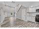 Open floorplan featuring hardwood floors, neutral paint, stainless appliances, and an abundance of natural light at 11657 Moore Rd, Lakeland, FL 33809