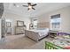 Spacious main bedroom with neutral colors, a tray ceiling, and ample natural light at 11657 Moore Rd, Lakeland, FL 33809