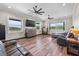 Spacious main bedroom with wood floors, ceiling fans and large windows overlooking the property at 11657 Moore Rd, Lakeland, FL 33809