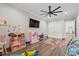 Spacious playroom features a ceiling fan, tv, and plenty of room for imagination at 11657 Moore Rd, Lakeland, FL 33809