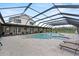 A screened-in pool featuring an attached spa and plenty of lounge seating with views of the surrounding area at 11657 Moore Rd, Lakeland, FL 33809