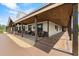 An exterior shot of a long covered porch with a wooden ceiling, columns, and a gravel garden area at 11657 Moore Rd, Lakeland, FL 33809