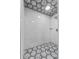 Modern shower with mosaic-patterned floor, white marble tiling and a rainfall shower head at 11657 Moore Rd, Lakeland, FL 33809