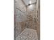 Tiled shower with pebble accents, recessed niche, and modern fixtures at 11657 Moore Rd, Lakeland, FL 33809