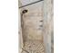 Tiled shower with a pebble floor and built-in shelving at 11657 Moore Rd, Lakeland, FL 33809