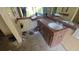 Bathroom needing remodeling with wood vanity, white sink, and a large framed mirror at 20045 Sw 88Th Place Rd, Dunnellon, FL 34431