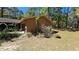 Side exterior view of house with an attached garage and natural surroundings at 20045 Sw 88Th Place Rd, Dunnellon, FL 34431