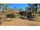 View of the back of the property with mature trees and flowering bushes at 20045 Sw 88Th Place Rd, Dunnellon, FL 34431