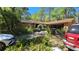 Exterior shot of the home with mature landscaping and an arched entrance at 20045 Sw 88Th Place Rd, Dunnellon, FL 34431