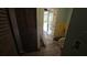 Hallway view showing closet, french doors to back, and damaged floor at 20045 Sw 88Th Place Rd, Dunnellon, FL 34431