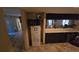 Galley kitchen featuring a refrigerator and contrasting dark cabinets at 20045 Sw 88Th Place Rd, Dunnellon, FL 34431