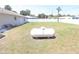 Spacious backyard with lush green grass, featuring a large propane tank in the center at 2521 Tamarind Dr, Edgewater, FL 32141