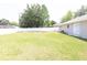 Large backyard featuring a well-maintained lawn and white vinyl privacy fence at 2521 Tamarind Dr, Edgewater, FL 32141