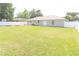 Wide view of backyard showing a lush green lawn and white vinyl fence at 2521 Tamarind Dr, Edgewater, FL 32141