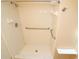 Shower features updated shower head, grab bars, and built-in seat at 2521 Tamarind Dr, Edgewater, FL 32141