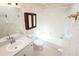 Bathroom with vanity, toilet and tub with shower; grab bars are installed near the tub at 2521 Tamarind Dr, Edgewater, FL 32141
