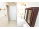 The bathroom includes a vanity, toilet, mirror cabinet, and tile flooring at 2521 Tamarind Dr, Edgewater, FL 32141