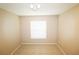 Bright bedroom features tan walls, tile flooring, a window with blinds, and modern ceiling lighting at 2521 Tamarind Dr, Edgewater, FL 32141