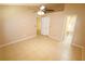 Bedroom featuring an open bathroom and neutral interior with tile flooring at 2521 Tamarind Dr, Edgewater, FL 32141
