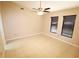 Bright bedroom features neutral walls, a ceiling fan, and tile flooring at 2521 Tamarind Dr, Edgewater, FL 32141