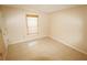 Neutral-walled bedroom with tile flooring and a window with a bamboo blind at 2521 Tamarind Dr, Edgewater, FL 32141