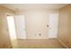 Bedroom features neutral walls and tile flooring with two open doors at 2521 Tamarind Dr, Edgewater, FL 32141