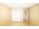 A bedroom features a closet with white doors, neutral walls, and tile flooring at 2521 Tamarind Dr, Edgewater, FL 32141