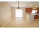 Inviting dining area with tile flooring, a stylish chandelier, and convenient access to the adjacent kitchen at 2521 Tamarind Dr, Edgewater, FL 32141