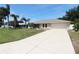 Attractive home with a concrete driveway complemented by a well-maintained lawn and attractive landscaping elements at 2521 Tamarind Dr, Edgewater, FL 32141