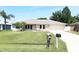 Charming single-story home with a well-manicured lawn and mature landscaping, creating a welcoming curb appeal at 2521 Tamarind Dr, Edgewater, FL 32141