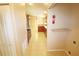 Hallway leading into kitchen has tile flooring and access to laundry room at 2521 Tamarind Dr, Edgewater, FL 32141