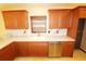 Kitchen boasts wood cabinets, granite countertops, stainless steel dishwasher, and tile flooring at 2521 Tamarind Dr, Edgewater, FL 32141