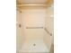 Shower featuring an updated shower head and built in grab bars for easy accessibility at 2521 Tamarind Dr, Edgewater, FL 32141