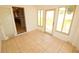 Cozy sunroom with tile flooring, glass doors, and natural light streaming in at 2521 Tamarind Dr, Edgewater, FL 32141