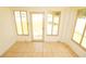 Sunroom with neutral tile flooring and windows overlooking the outdoor space at 2521 Tamarind Dr, Edgewater, FL 32141