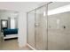 Modern bathroom featuring a tiled shower with glass doors and a glimpse of bedroom at 4500 Monado Dr, Kissimmee, FL 34746