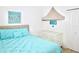 Bright bedroom with queen bed and beige canopy over crib, featuring unique nautical artwork at 4500 Monado Dr, Kissimmee, FL 34746