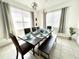 Inviting dining room featuring a rustic wood table, bench seating, and stylish pendant lighting at 4500 Monado Dr, Kissimmee, FL 34746