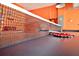 Close up of the ping pong net in a game room featuring bright orange walls at 4500 Monado Dr, Kissimmee, FL 34746