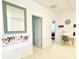 Hallway featuring a mirror and desk area, leading to various rooms within the home at 4500 Monado Dr, Kissimmee, FL 34746