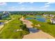 Lovely aerial view showcasing the golf course, lake, and surrounding community at 1514 Corolla Ct, Reunion, FL 34747