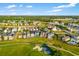 Beautiful aerial view showcasing the neighborhood and surrounding golf course, perfect for outdoor activities at 1514 Corolla Ct, Reunion, FL 34747