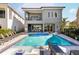 Stunning backyard pool with a spa, lounge chairs, and outdoor kitchen, perfect for relaxation and entertaining at 1514 Corolla Ct, Reunion, FL 34747